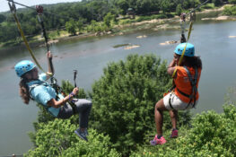 Experience the thrill of the Blue Heron Zip Line, offering an exhilarating interstate ride with stunning views of the Chattahoochee River. | Photo Credit: Courtesy of VisitColumbusGA